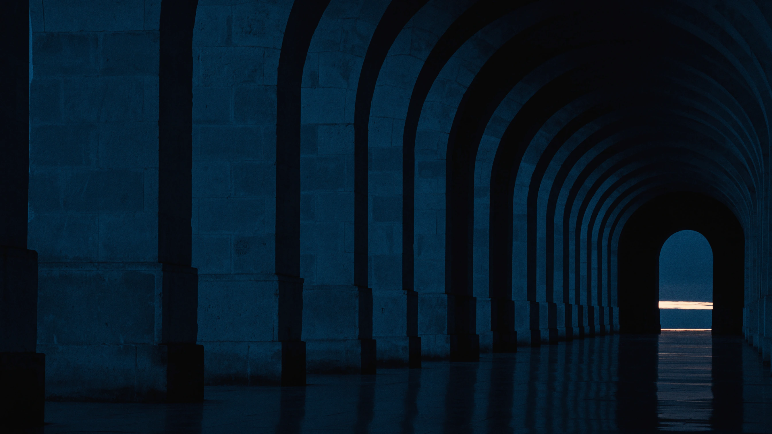 The empty pavilion holds a thin line of morning light through its final arch.