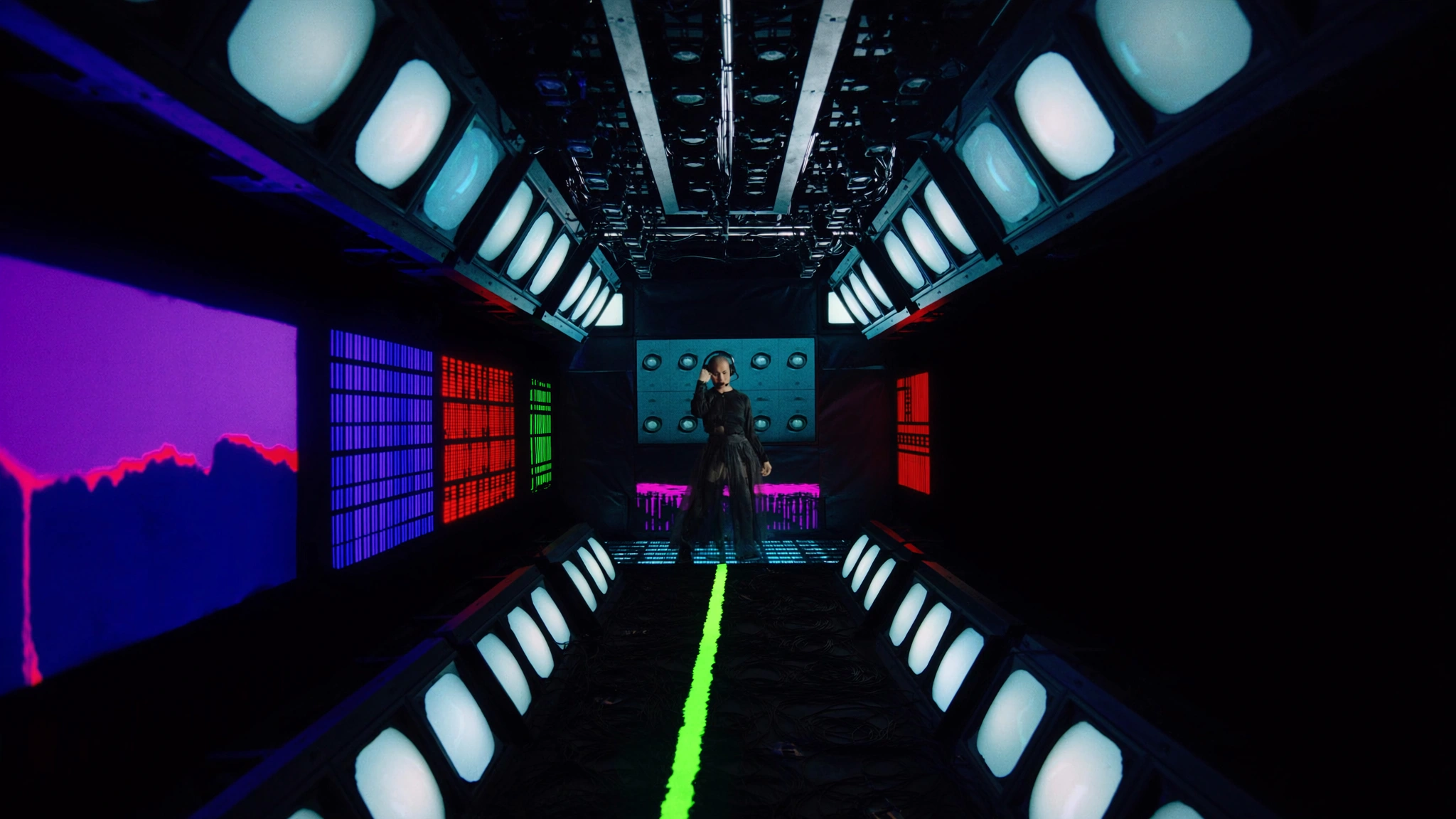 CRT banks and an LED field create a deep live-broadcast room.