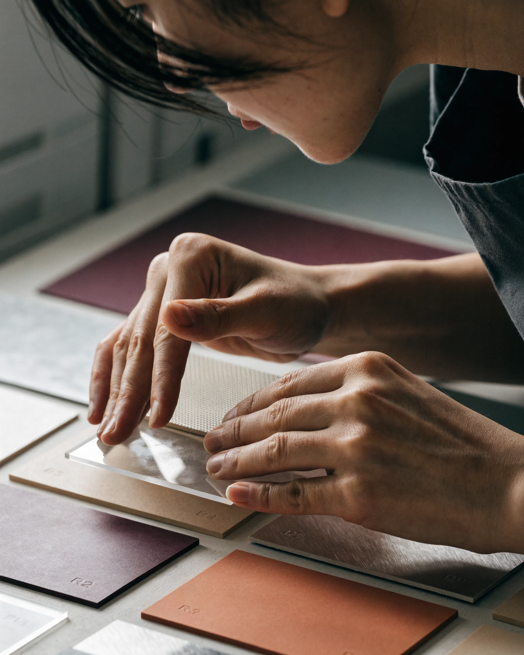 A participant compares coded materials by touch without seeing their hues.